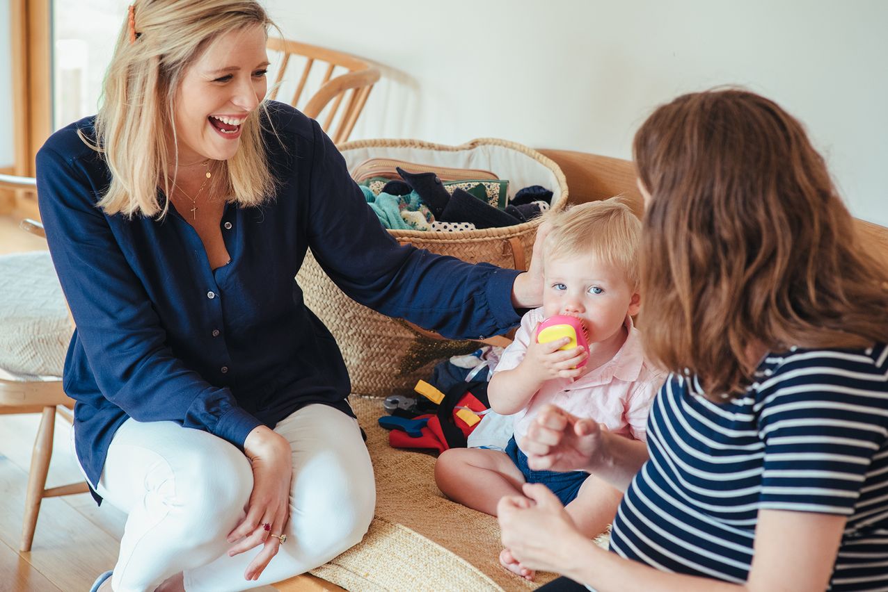 Two parents talking with a baby